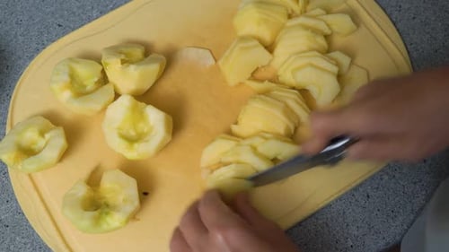 Woman Peeling and Cutting Apples for Apple Cake