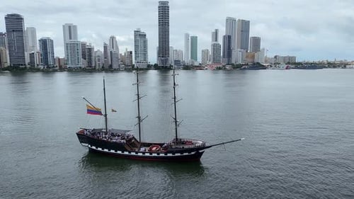 Aerial Shot of Tourist Boat near Urban Coastline