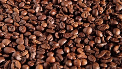 Coffee Beans Background Texture of Coffee Beans Close Up Dark Brown Roasted Coffee is Spinning