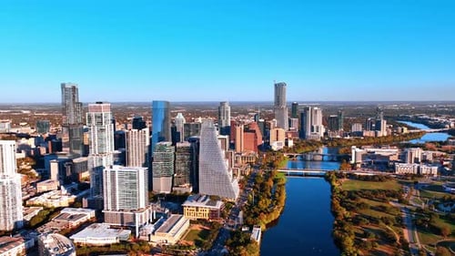 Peaceful wavy Colorado River flowing by the cityscape of Austin, Texas, USA.
