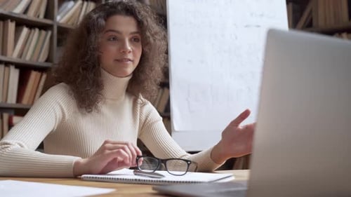 Hispanic Teen Girl School Student Study by Webcam Video Conference Call Online