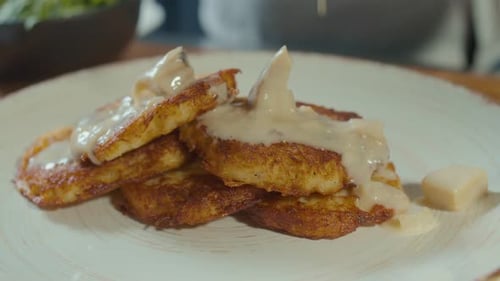 Closeup of Professional Cook Stylishly Serving Crust Golden Potato Pancakes