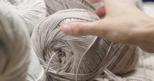 Close up of a hand touching raw, warm and soft wool. Concept of: tenderness, softness, warm, cloth
