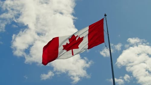 Canadian Flag Waving Against a Blue Sky