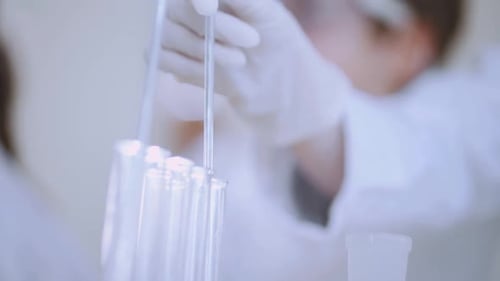 Close Up of Lab Technician with Glassware