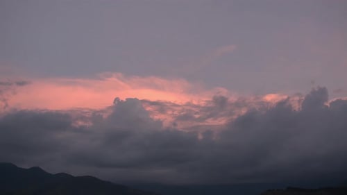 Sunset Clouds Over Rolling Hills Landscape
