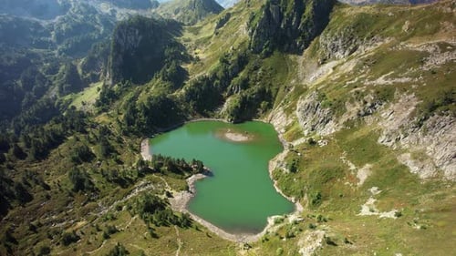Aerial views of an alpine lake in the french Pyrenees at low altitude