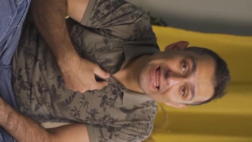 Vertical video of The man who is angry at the camera.