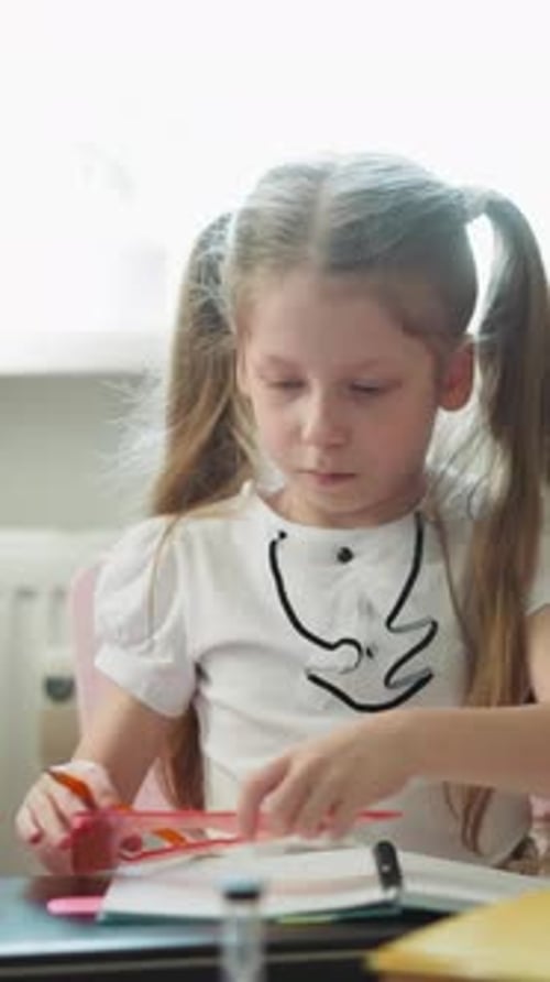 Schoolgirl Draws Triangle in Paper Notepad Using Set Square