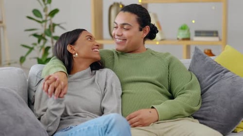 Affectionate Couple Laughing Together on Sofa