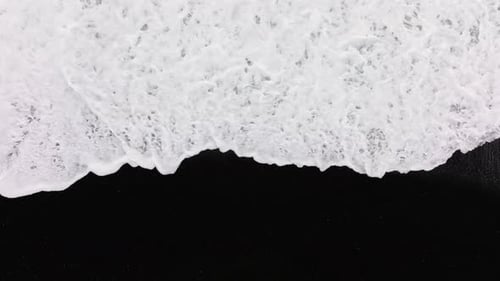 White Tide Washing Over Black Sand Beach