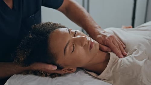 Young Woman Receives Therapeutic Neck Massage