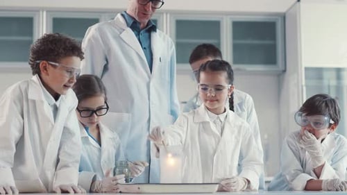 Children Enjoy Science Experiment in Classroom with Teacher