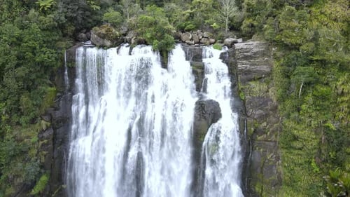 Slow Drone shot moving away from a Waterfall and natural sights in New Zealand