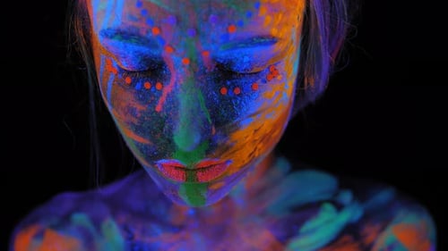 Woman with Bright Ultraviolet Makeup Against Black Background