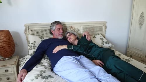 Affectionate Senior Couple Relaxing Together in Bed