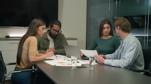 Adults Collaborate on Office Project in Conference Room