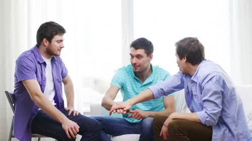 Three Men Celebrate Together Indoors