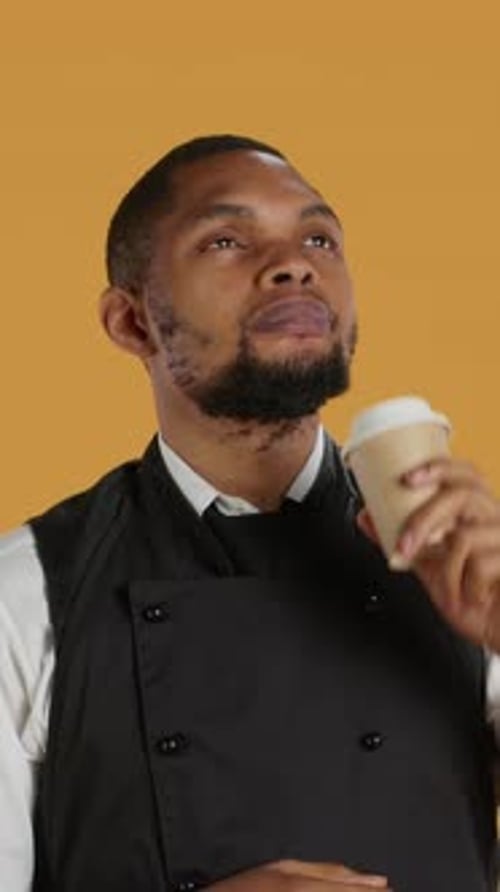 Vertical Video Restaurant Waiter Enjoying a Cup of Coffee Drink on His Work Break