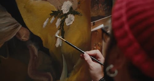 Male Artist Paints a Canvas in His Art Studio