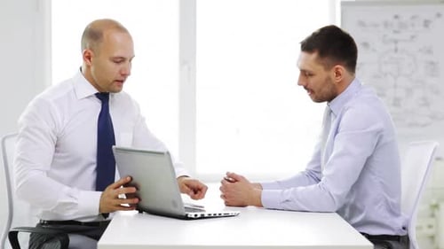 Business, Technology, Finances and Office Concept - Two Smiling Businessmen with Laptop