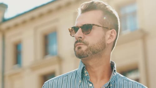 Man Wearing Sunglasses and Striped Shirt Gazing