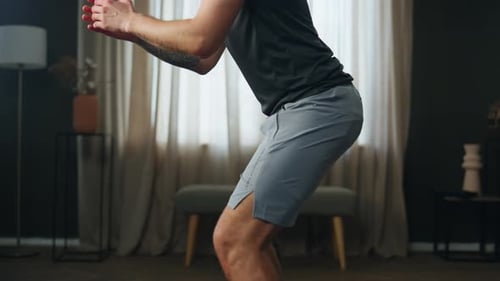 Man Doing Squats at Home for Fitness