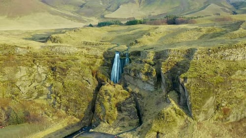 Inspiring landscape with a magnificent waterfall in steep rocky canyon, Iceland