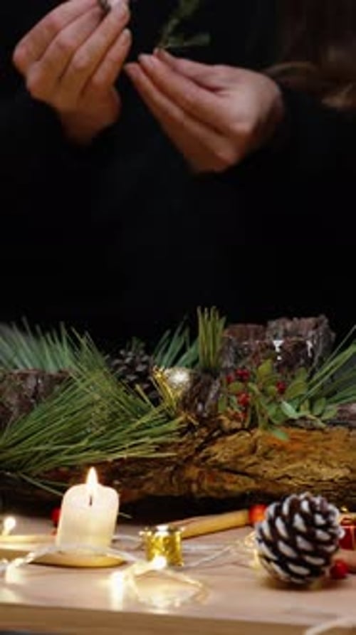 Vertical video. Festive mood in the workshop, the young woman makes a composition for the decor of t