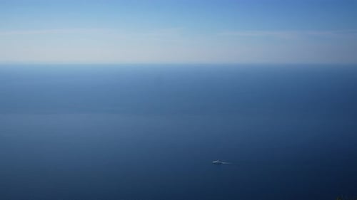 Cinematic Remote Top View From Rock to Lonely Yacht Boat Sailing on Mediterranean Sea on Background