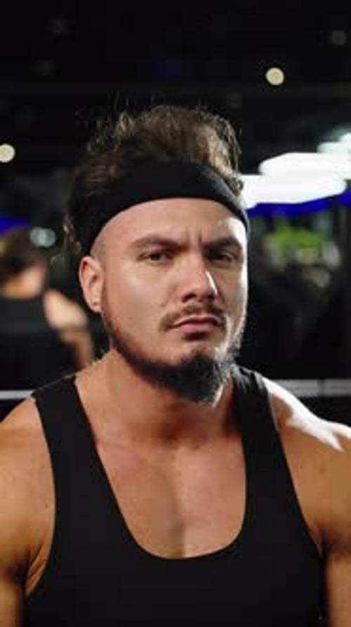 Focused Muscular Man in a Black Tank Top and Headband at the Gym Captured in Closeup Portraits
