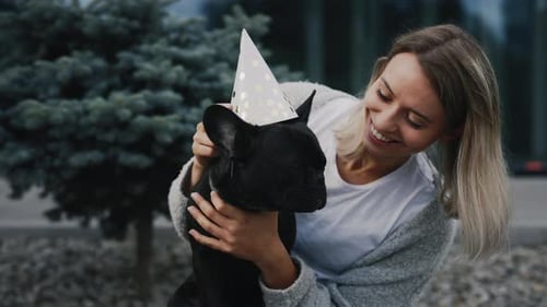 Woman Celebrates Dog's Birthday With Festive Hat