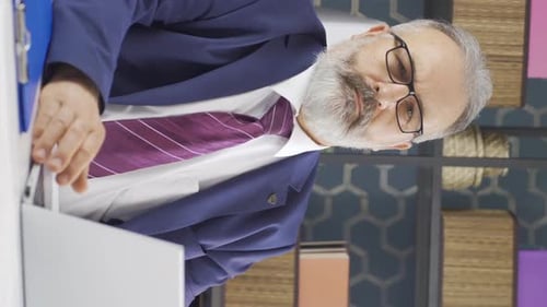 Man in Suit Working on Laptop in Office