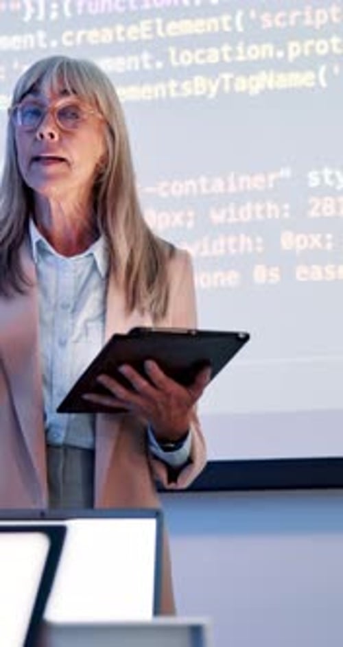 Coding, lesson and teacher class slides at academy with mature woman, speaker
