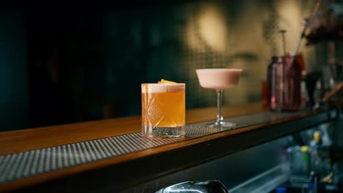 Close-up of ready-made delicious alcoholic cocktails standing on the bar and waiting for the guest