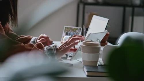 Hands of Unrecognizable Young Woman Working on Tablet and Laptop in Office