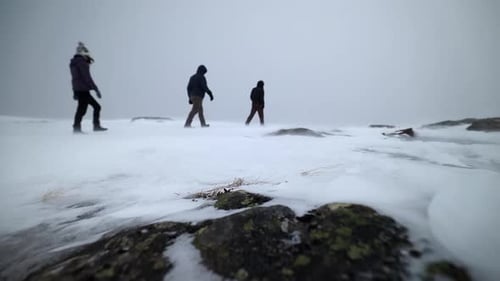 Hikers Walking on Snow Covered Mountain in Winter