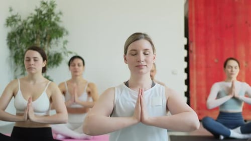 Yoga Mindfulness Meditation Group of Sporty People Doing Exercise in Studio for Class for Yoga