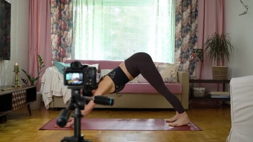 Woman Doing Yoga Exercises In Her Home
