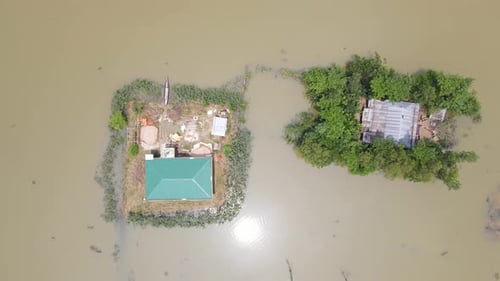 Remote houses surrounded by flood water in natural disaster, aerial view in Bangladesh village, Sout