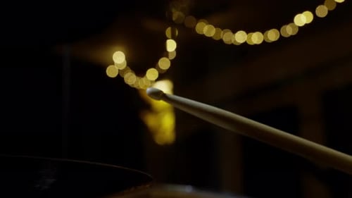 Drum Stick Hitting Drums at Night