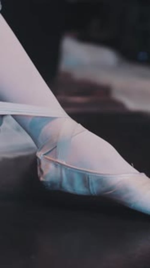 Ballerina Tying Satin Ribbons on Pointe Shoe