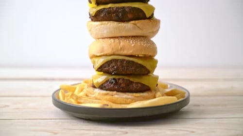 Towering Double Cheeseburger on Plate with Fries