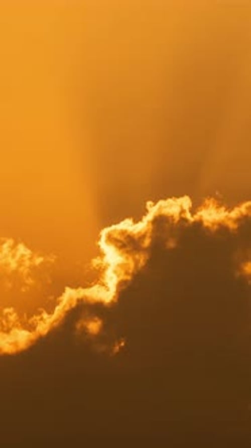Sun Rising Behind Clouds During Golden Hour
