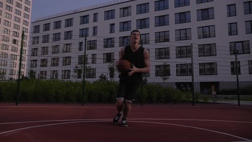 Sportive Man Play in Streetball on the Urban City Area Surrounded By
