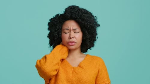 Woman Massaging Jaw Due to Tooth Pain
