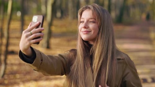 Attractive Young Female Enjoying Sunny Autumn Weather in Park