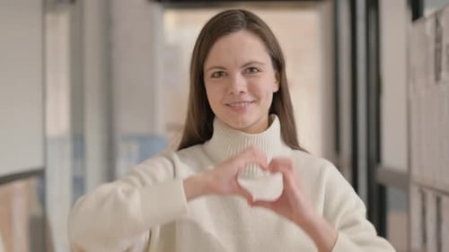 Smiling Woman Makes Heart Shape With Hands