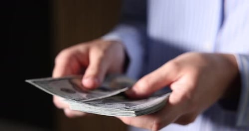Woman counting her money indoors, closeup view
