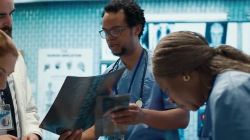 Medical Team Reviews X-Rays in Hospital Room